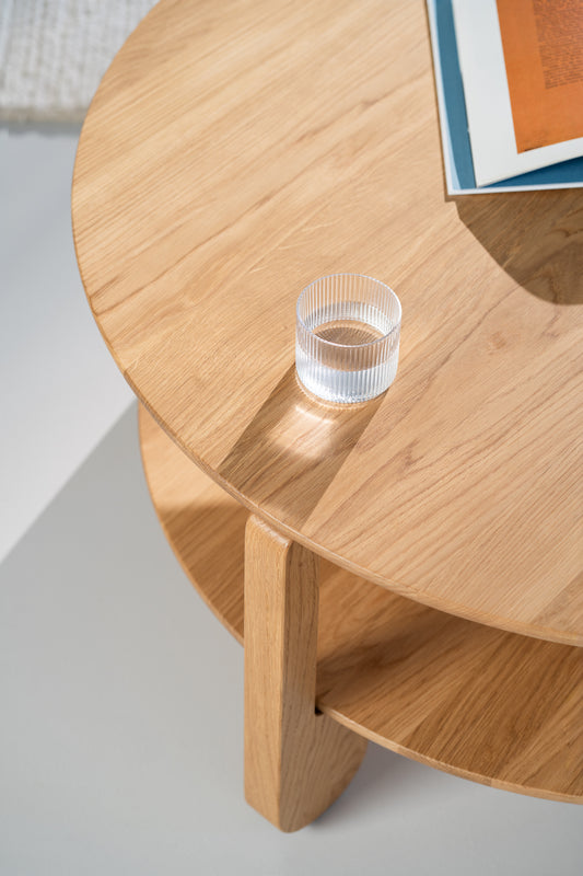Side profile of NOON solid oak coffee table with visible round tabletop edge