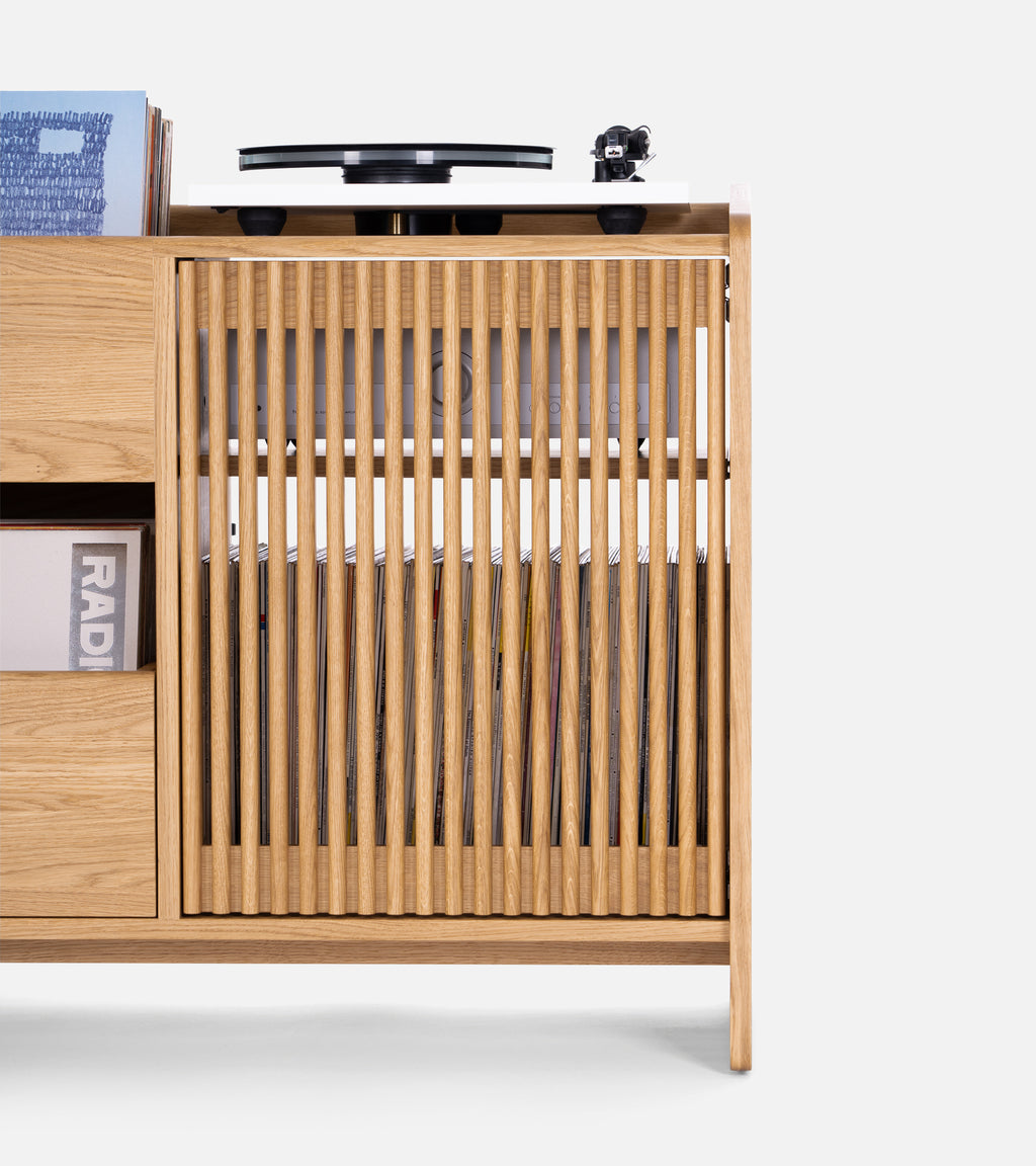 A wooden cabinet with a turntable and space for vinyl records.