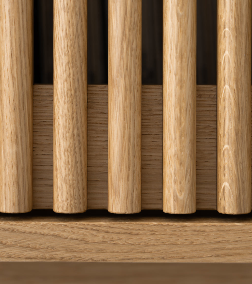 A close-up of a wooden grid with vertical slats.