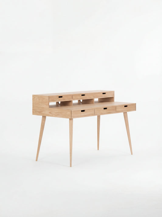 Wooden writing desk with slim legs and multiple drawers, set against a white background.