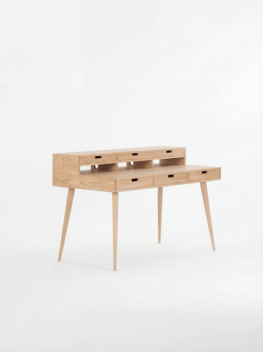 Wooden writing desk with slim legs and multiple drawers, set against a white background.