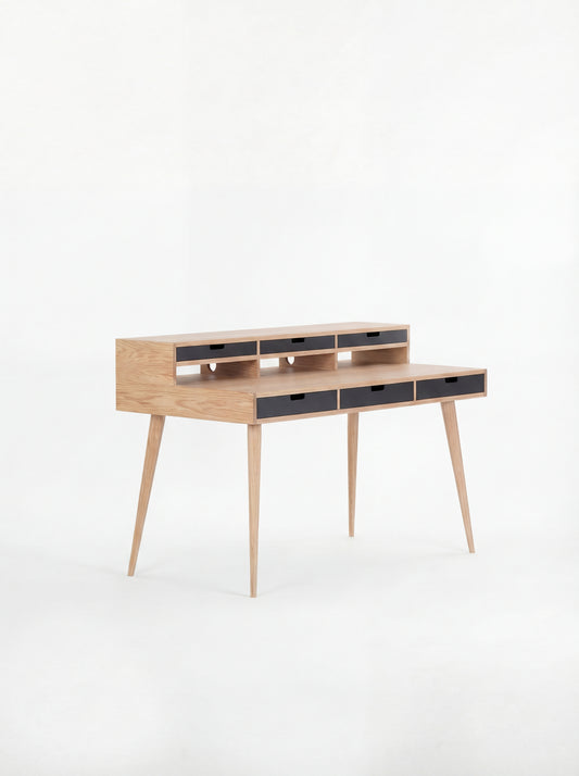 Wooden writing desk with slim legs and multiple drawers, set against a white background.