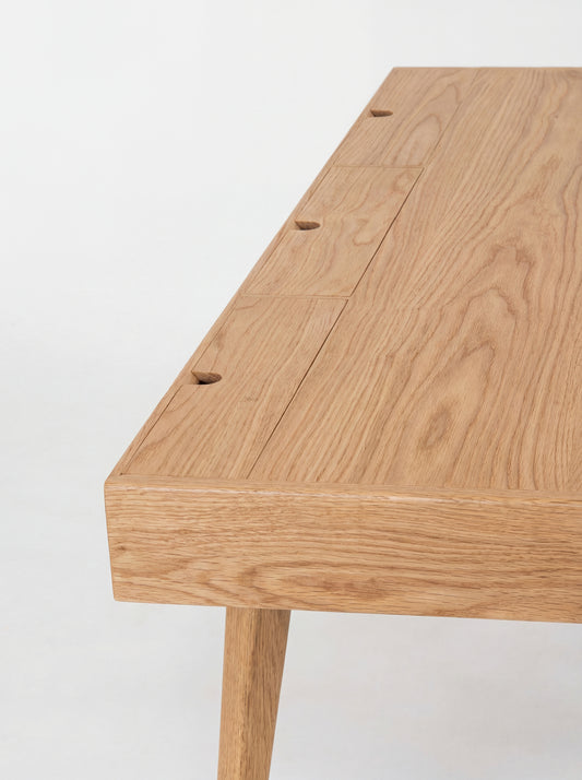 HEIM 140 desk in oak wood, close-up from above of three closed cable flaps with semicircular notches