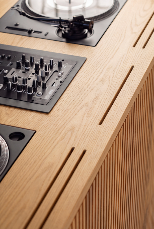 Overhead close-up of LOOP in solid oak, showing a flush-mounted turntable and mixer with slots along the front edge