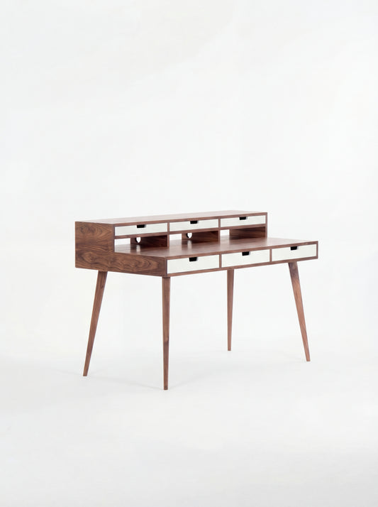 Mid-century modern wooden desk with narrow drawers and tapered legs.