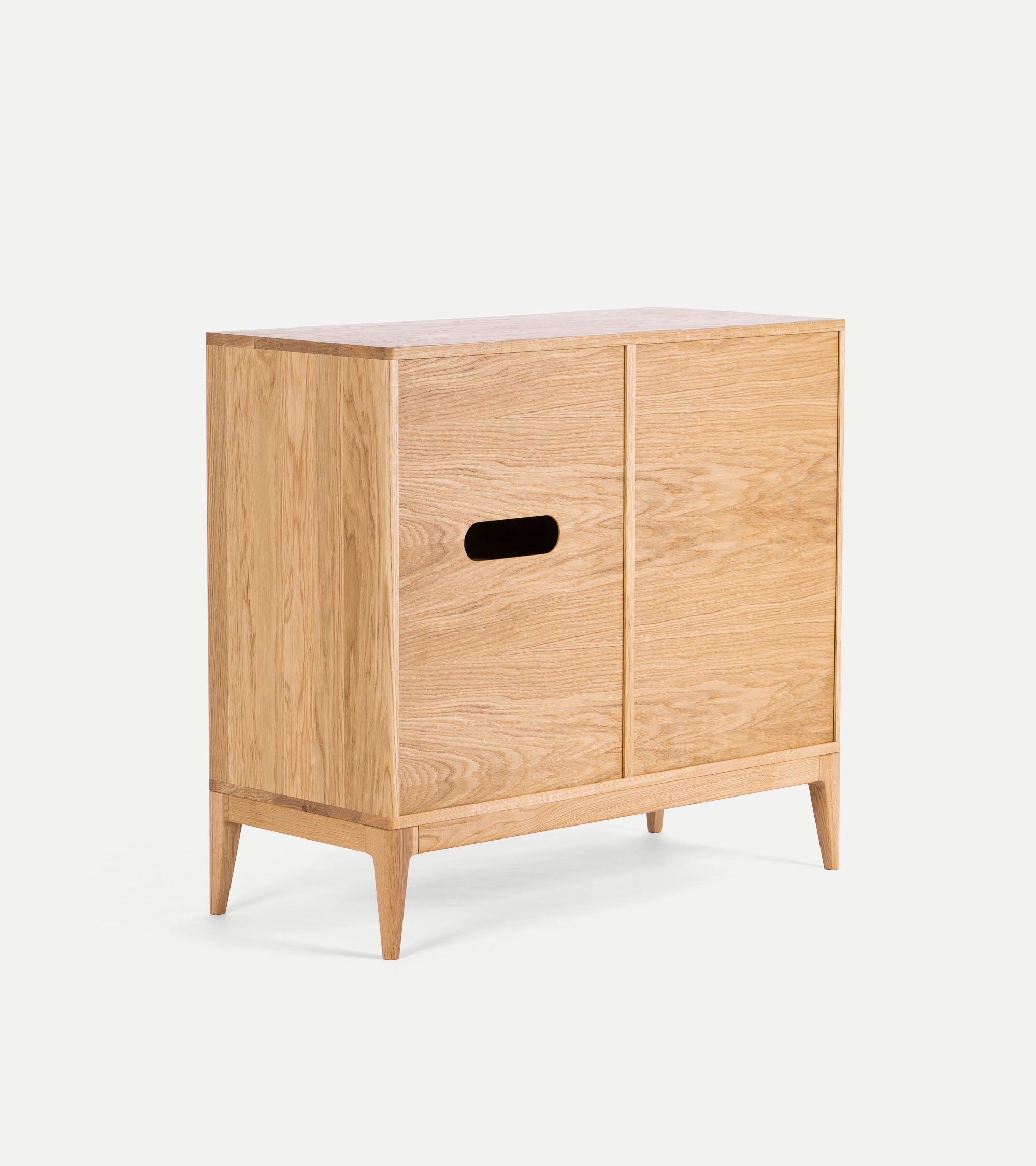 Back of wooden cabinet with cable hole and angled legs.