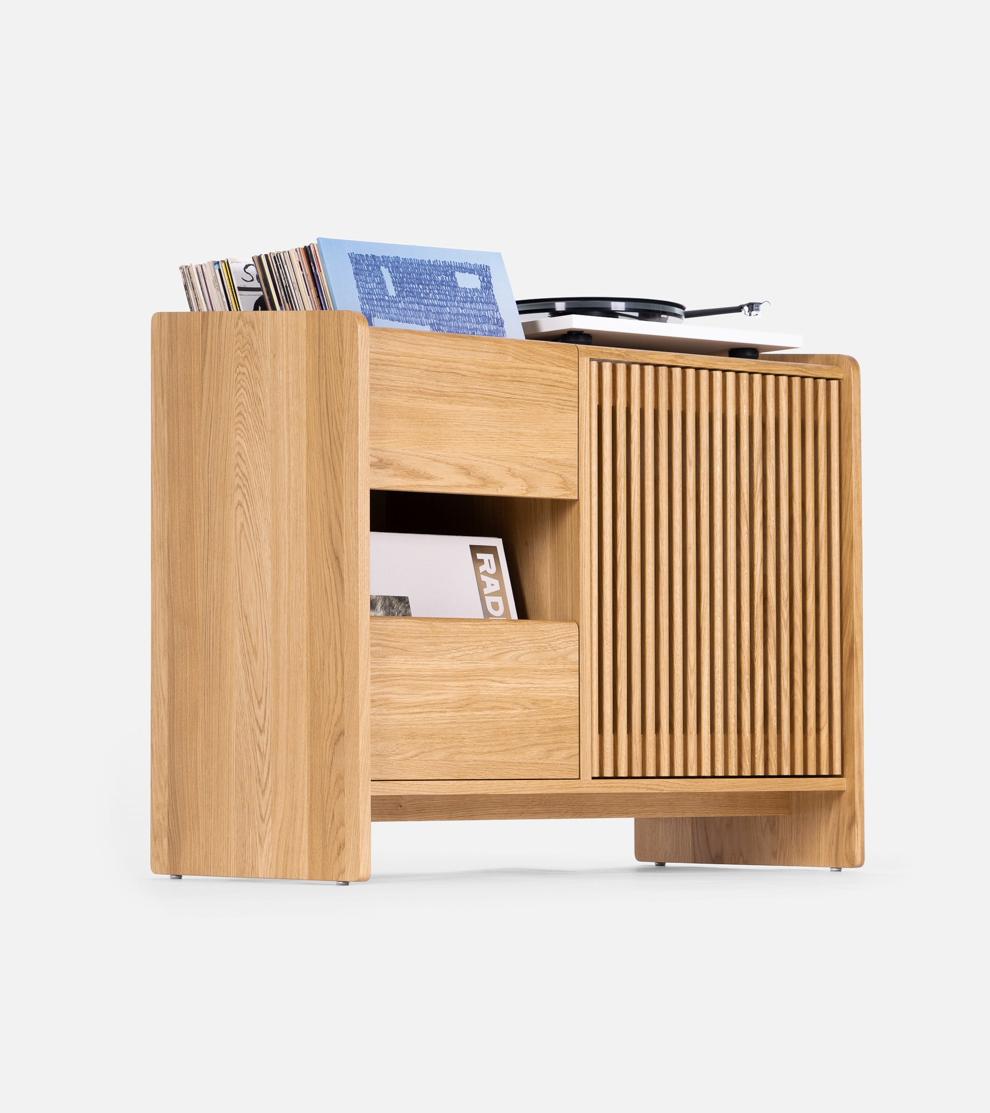 A wooden record player cabinet with shelves and a compartment holding vinyl records and a turntable on top.