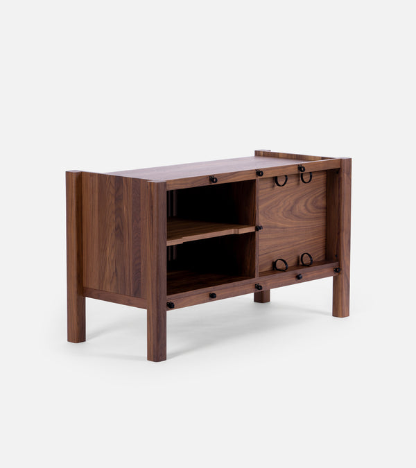 Wooden sideboard with open shelves and two closed compartments, featuring black circular handles.