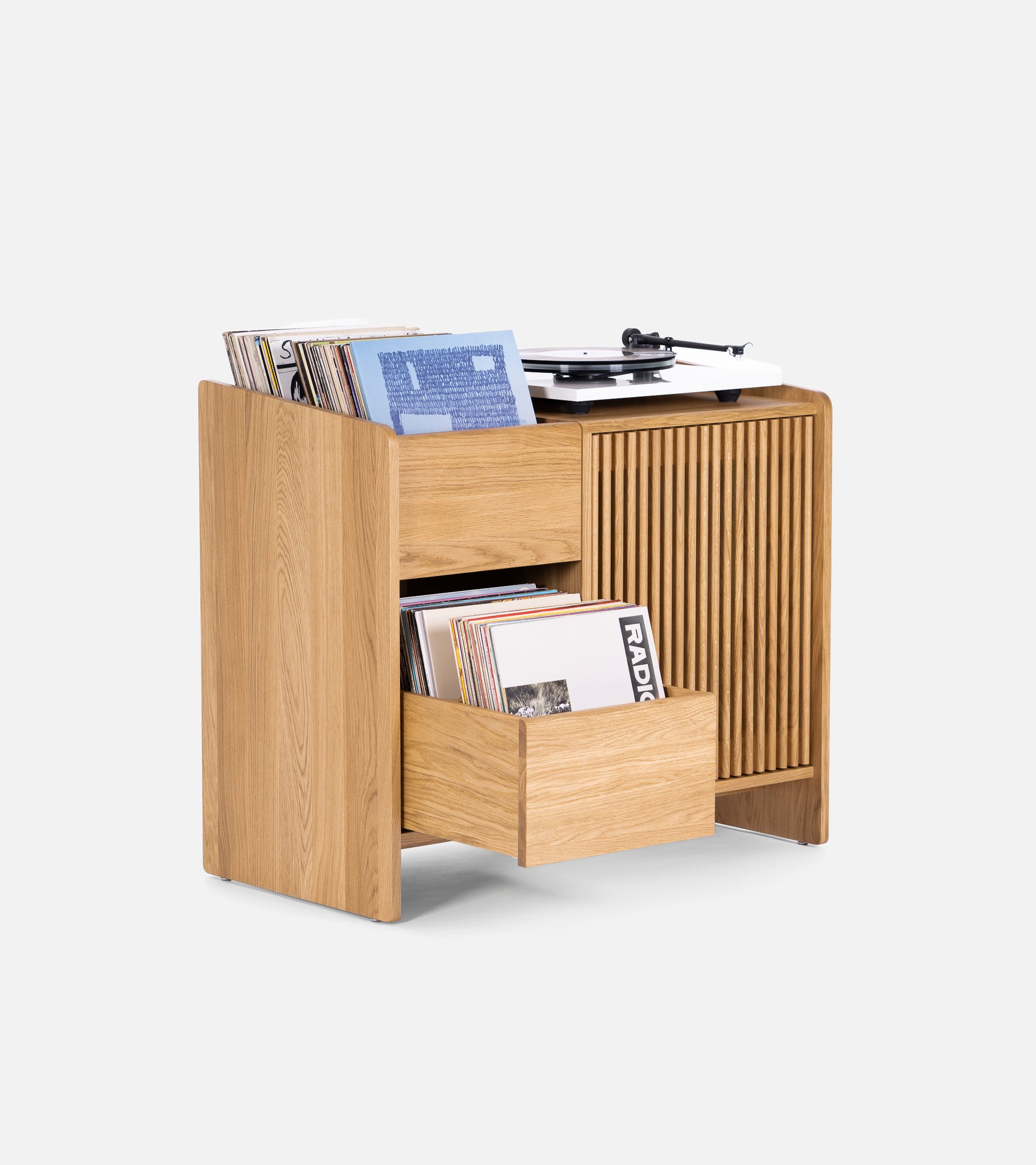 Wooden vinyl record storage unit with a turntable on top and two open drawers filled with records.