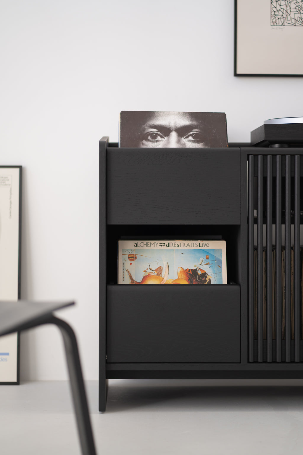 Black shelves with vinyl records in a modern interior.