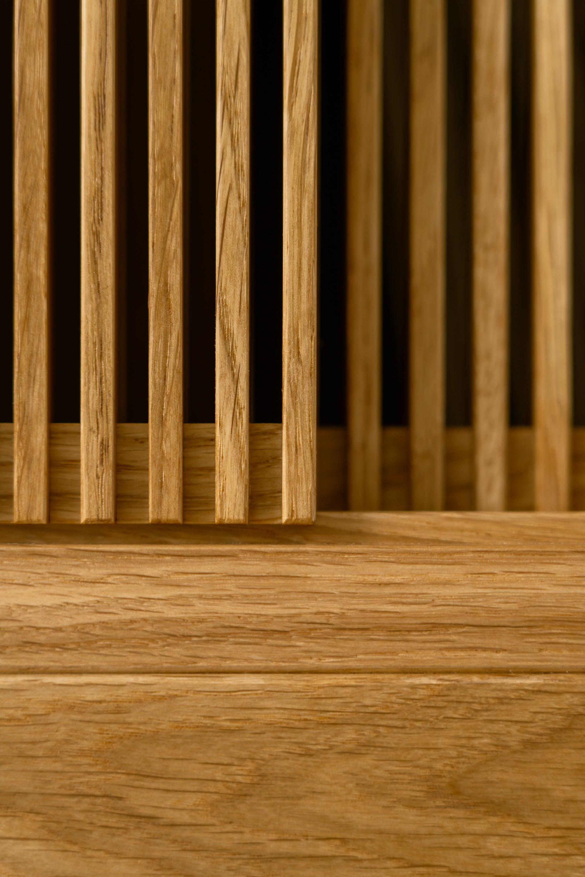 Close-up of vertical wooden slats with horizontal wood pane below.