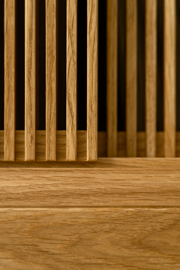 Close-up of vertical wooden slats with horizontal wood pane below.