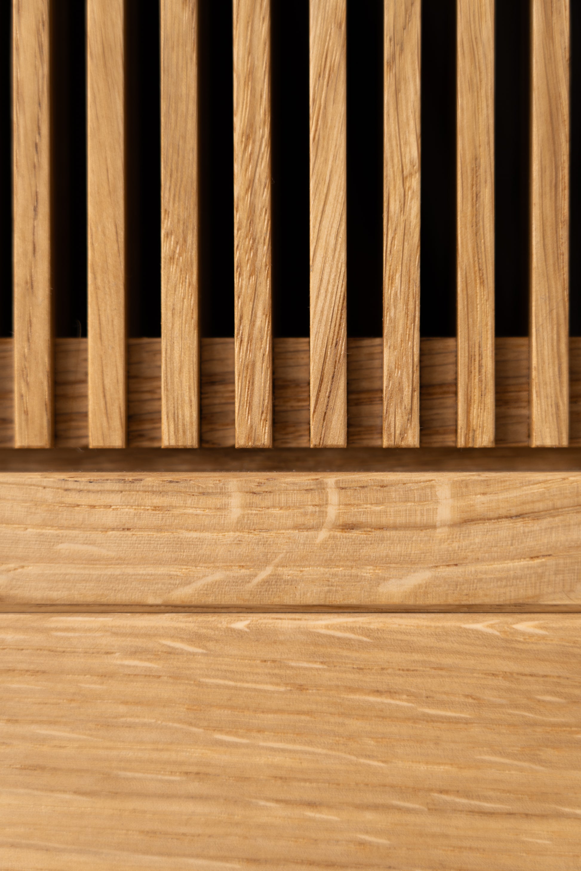 Close-up of a wooden slatted panel with vertical and horizontal grain patterns.