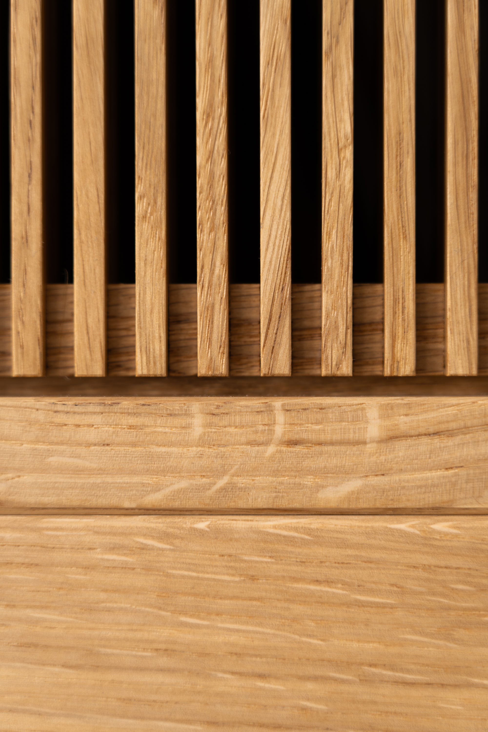 Close-up of a wooden slatted panel with vertical and horizontal grain patterns.