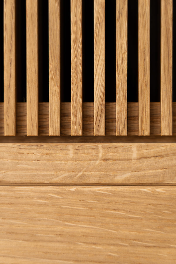 Close-up of a wooden slatted panel with vertical and horizontal grain patterns.