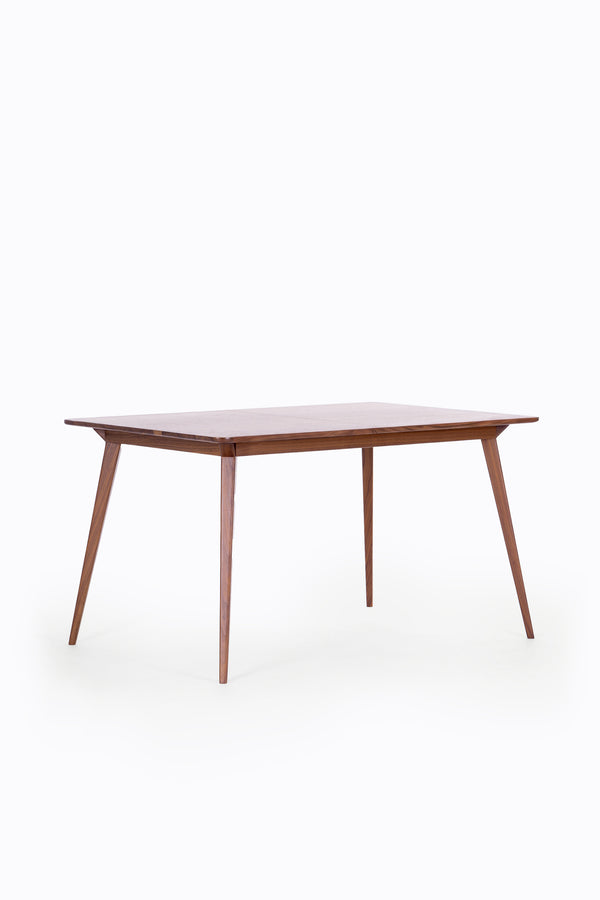 A wooden rectangular table with tapered legs on a white background.