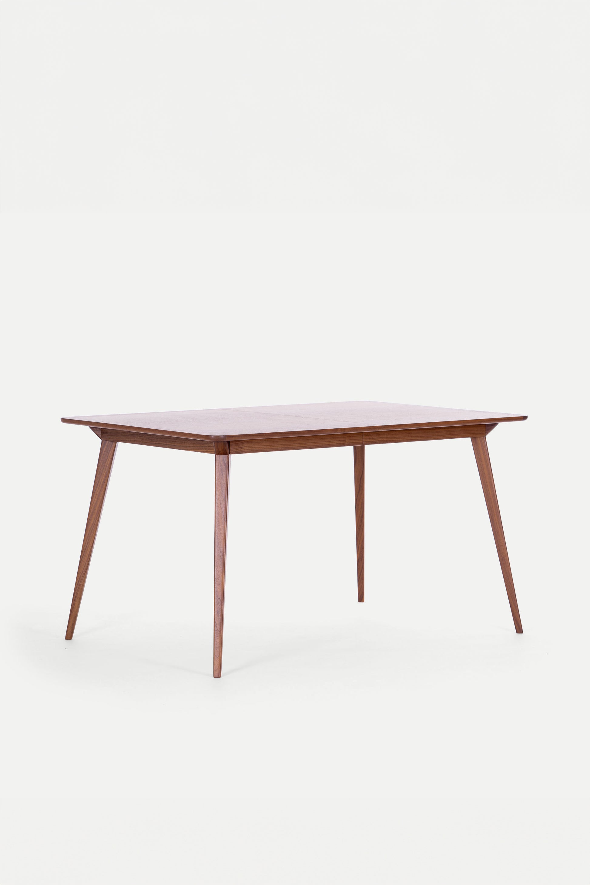 A wooden rectangular table with tapered legs on a white background.