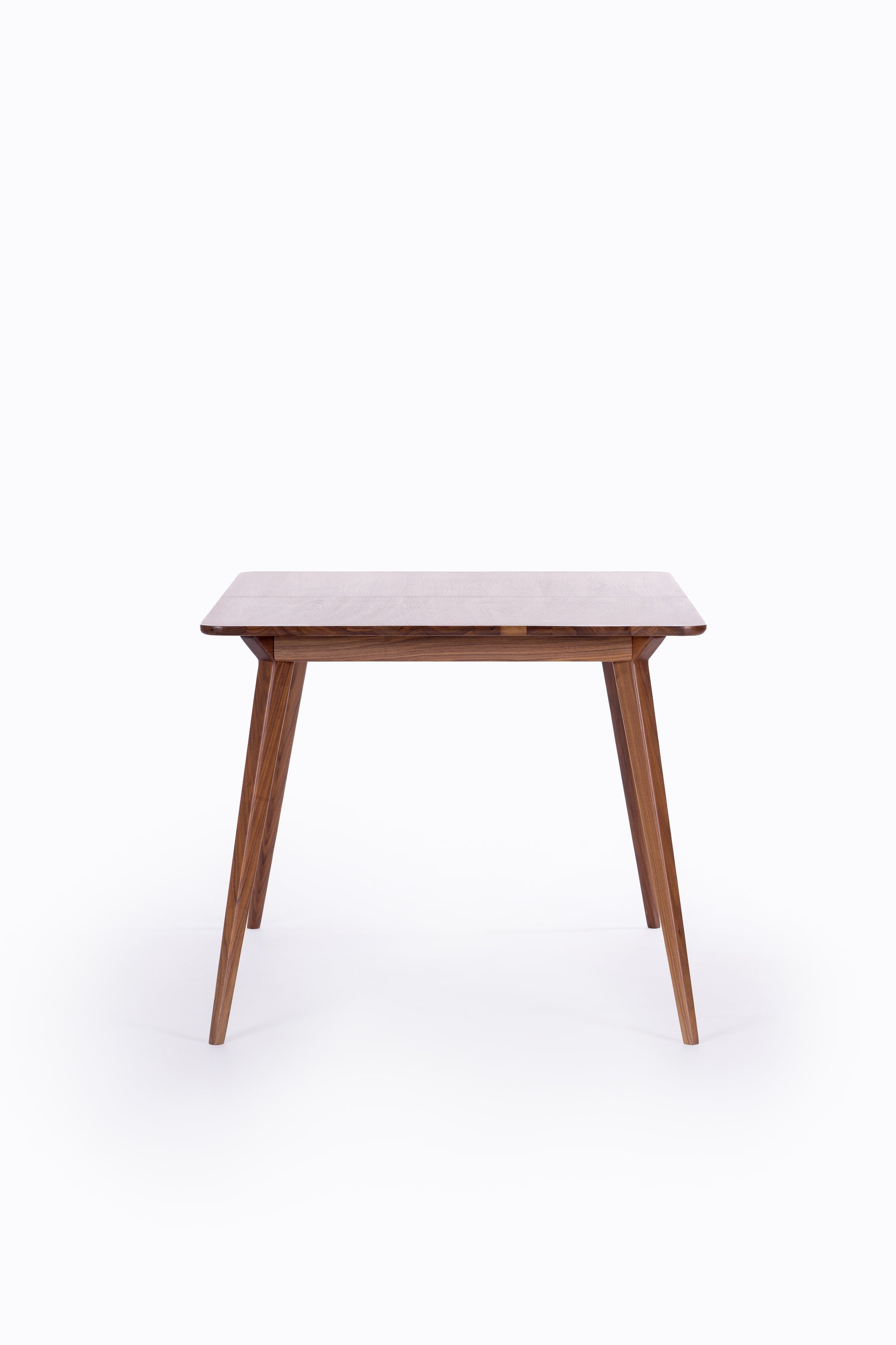Wooden table with tapered legs on a white background.