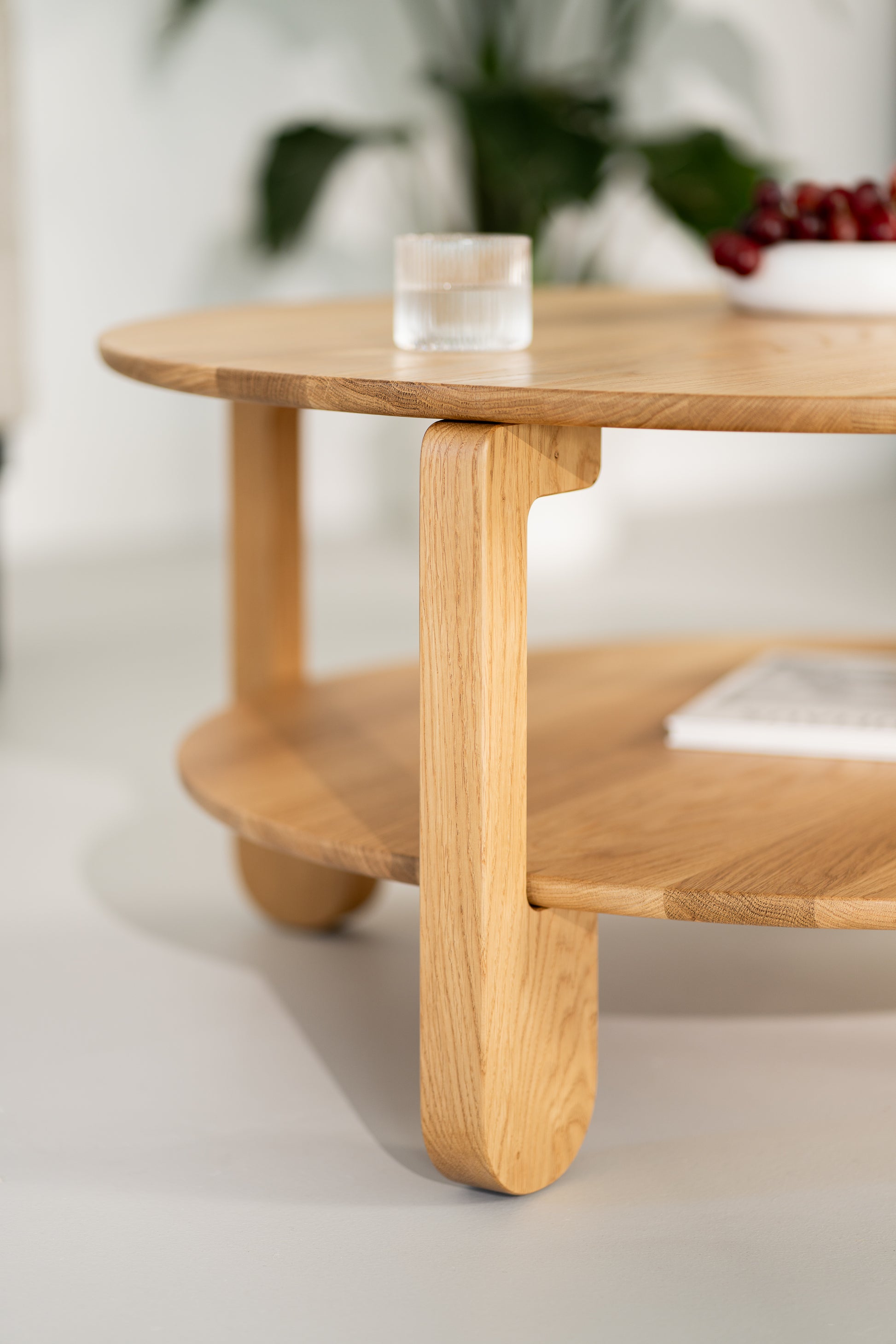 Hand resting on the surface of NOON solid oak coffee table, showing smooth oil-wax texture