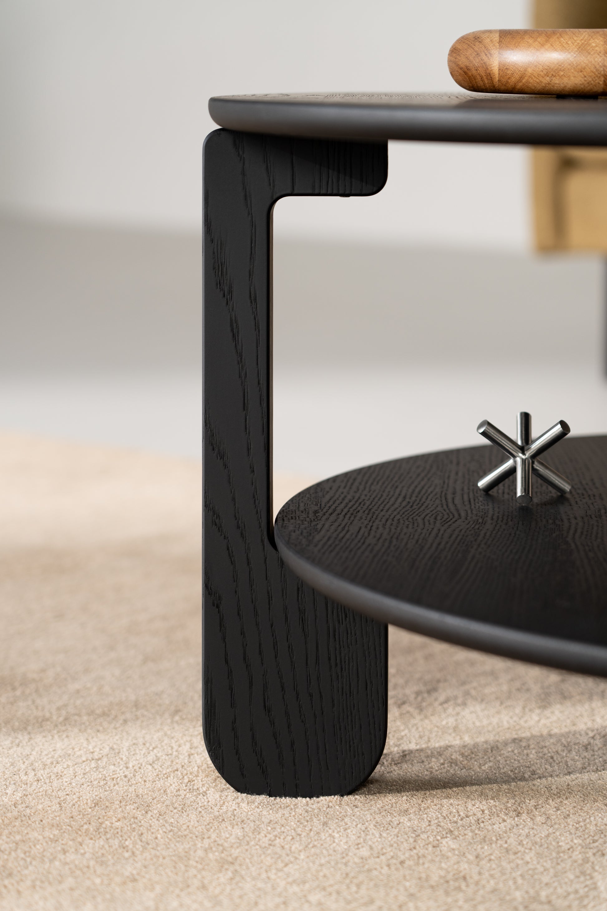 Three-quarter view of the NOON black coffee table against a white wall