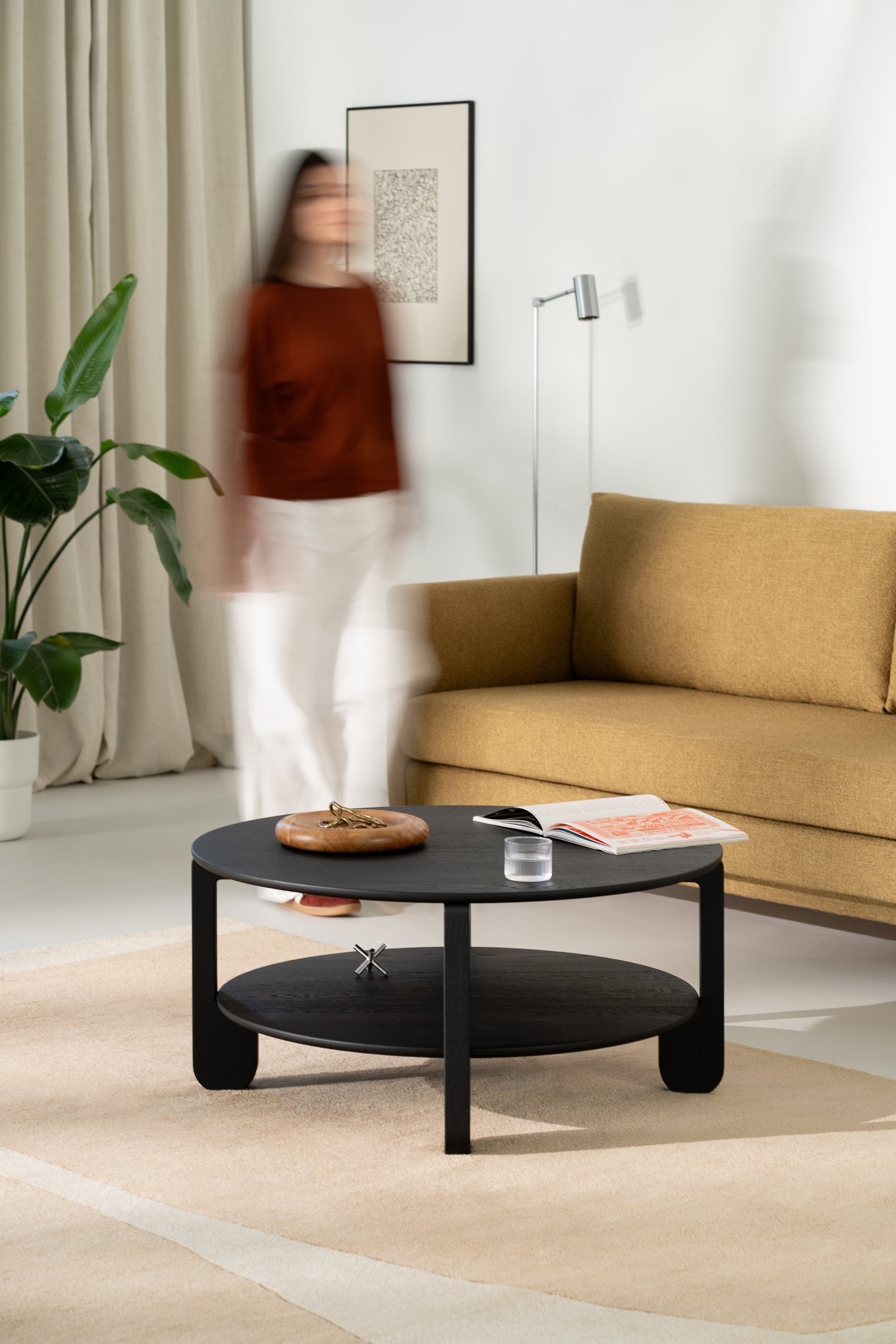 Leg detail of the NOON coffee table showing the soft taper from top to floor