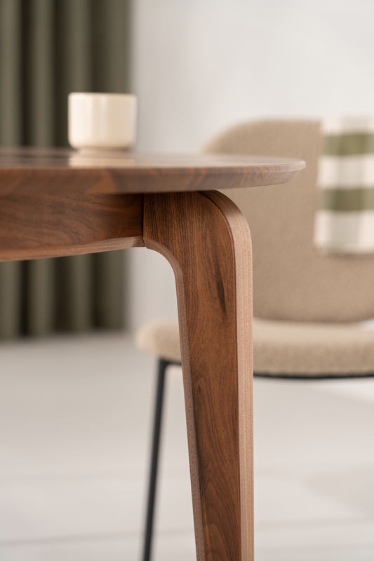 YUKI walnut dining table in a bright room with four chairs arranged around it