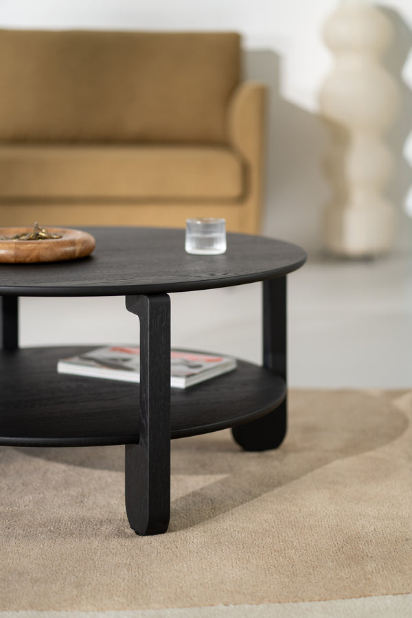 NOON black oak coffee table in a minimalist living room next to a low sofa