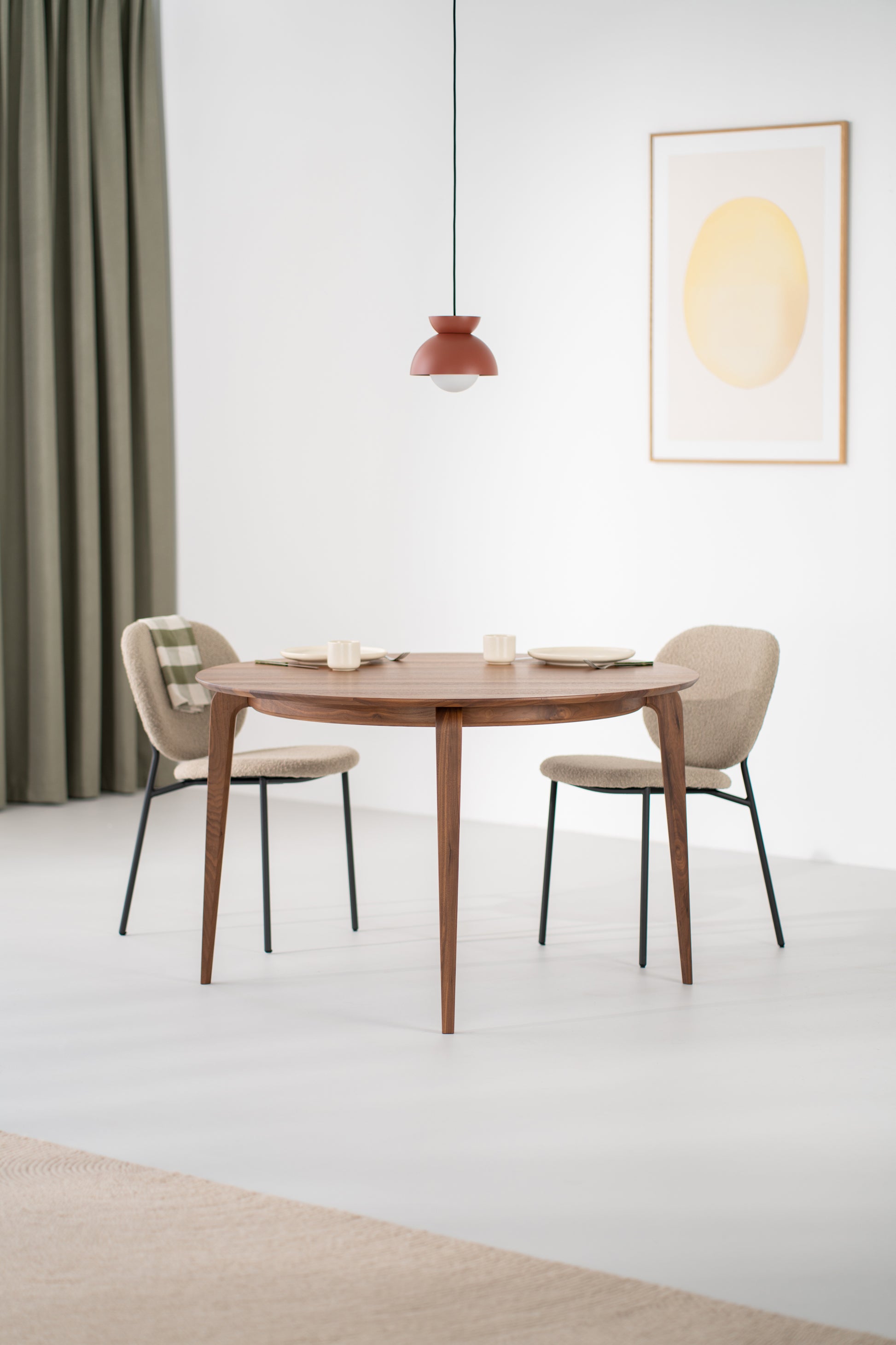 YUKI walnut dining table styled in a minimalist dining room with neutral walls