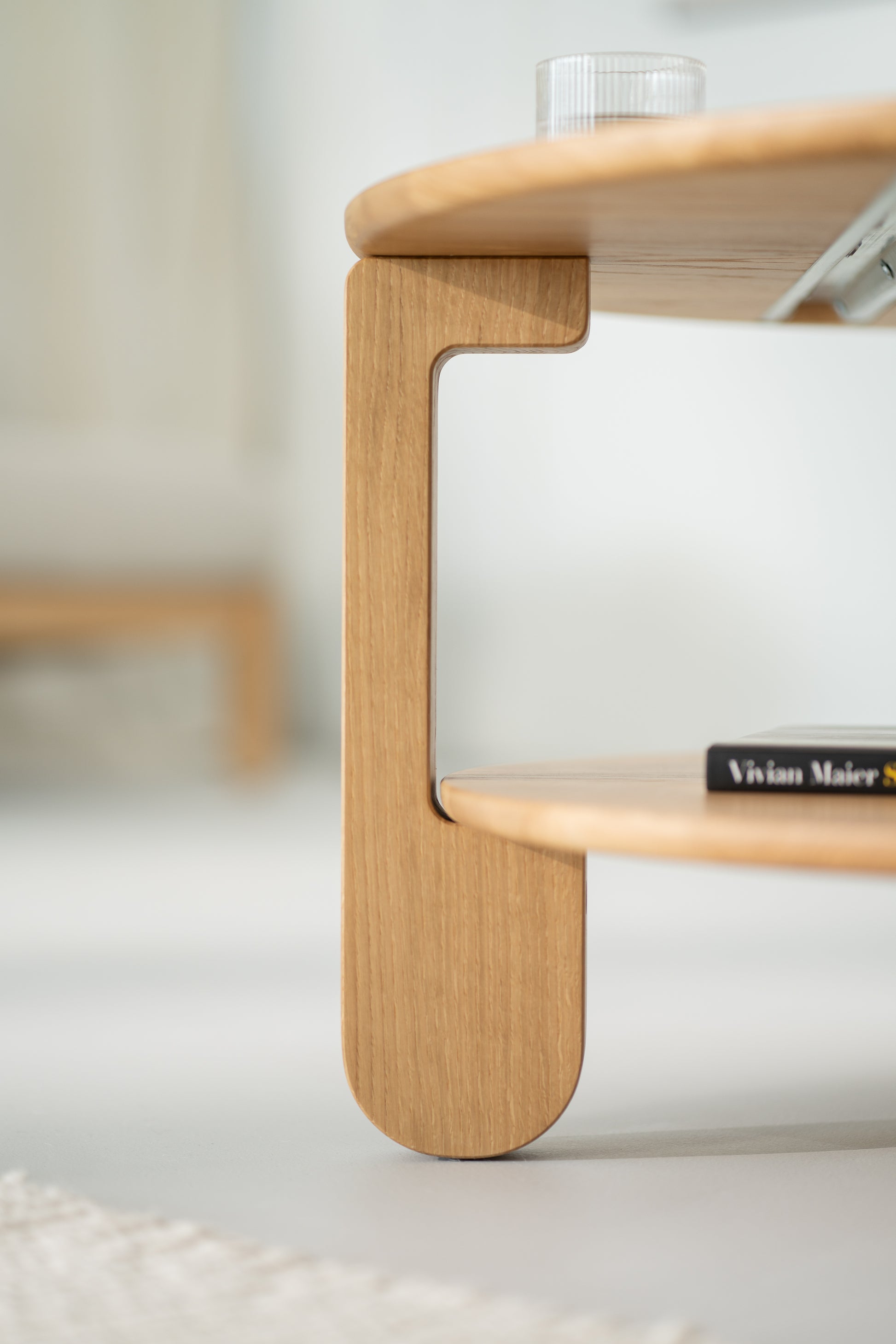 NOON round coffee table viewed at an angle, highlighting tapered legs and round top