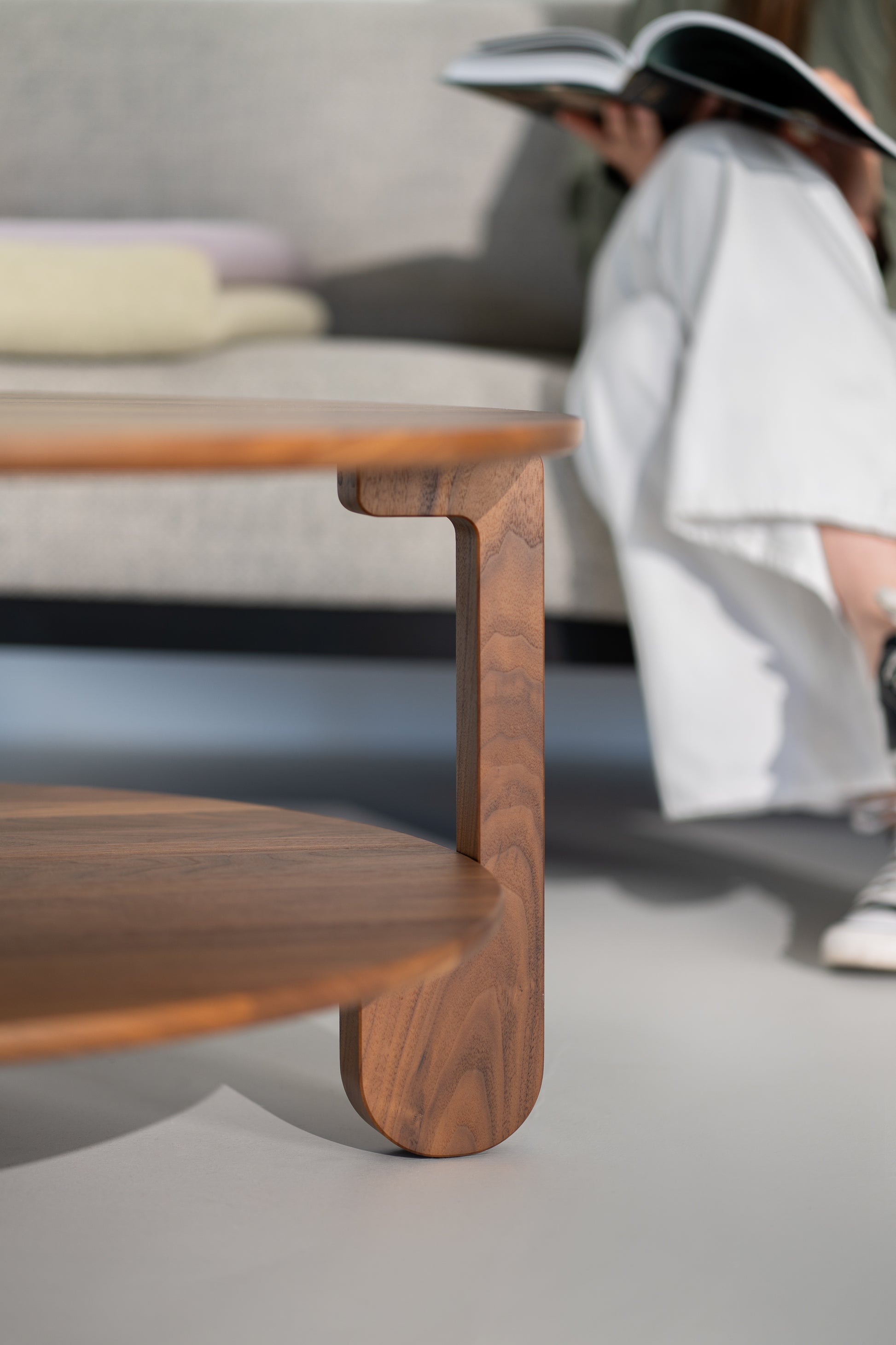 Detail of the NOON table leg where it meets the round walnut tabletop
