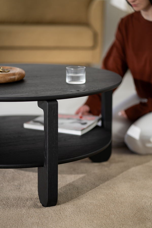 Detail of the leg joint on the NOON coffee table in black-finished solid oak