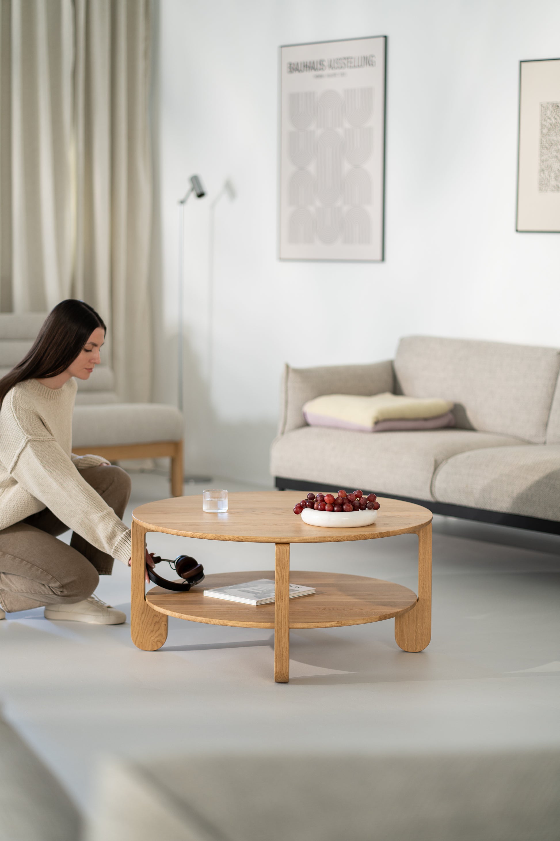 NOON solid oak coffee table next to a low armchair in a minimalist interior