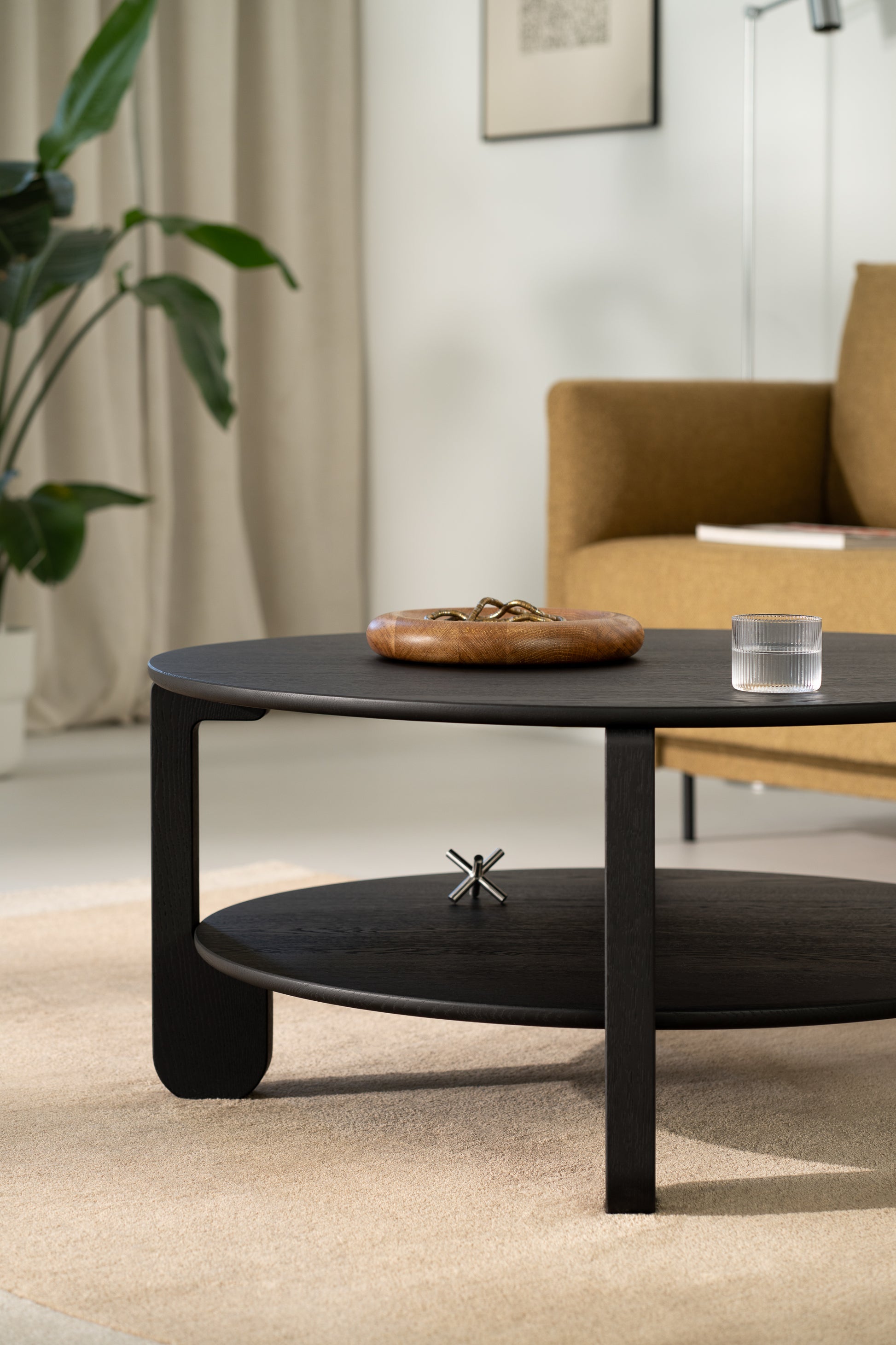 Underside view of the NOON table showing solid oak construction and leg attachment