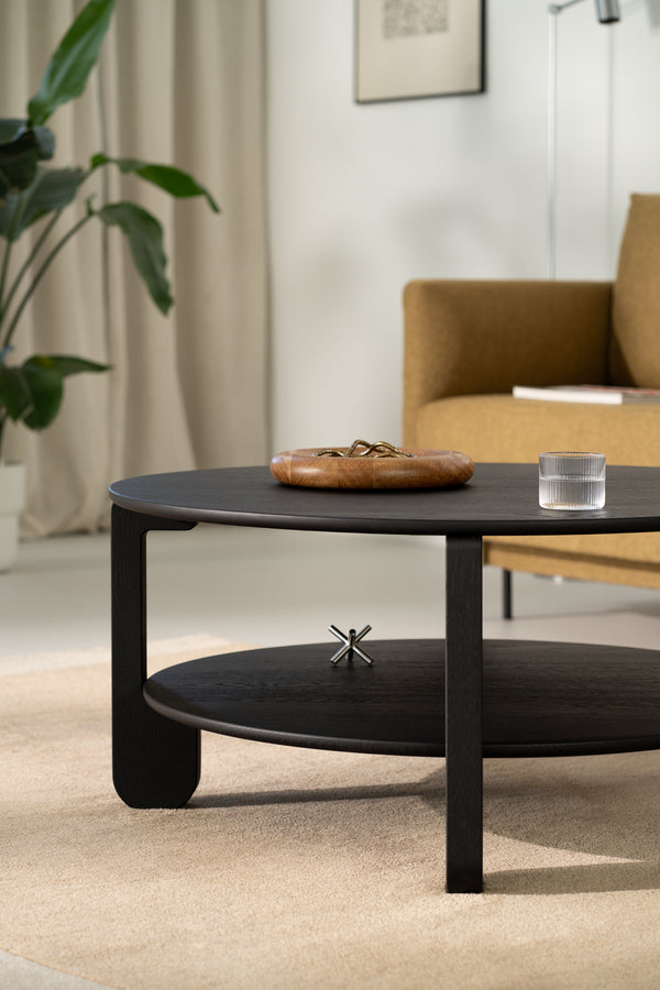 Underside view of the NOON table showing solid oak construction and leg attachment