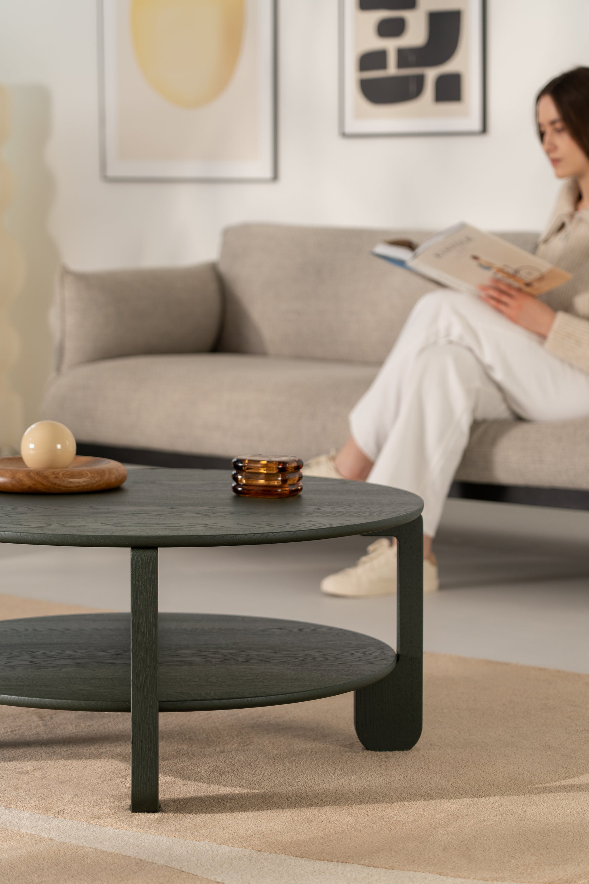 NOON dark green round coffee table next to a wool rug in a Japandi-style interior