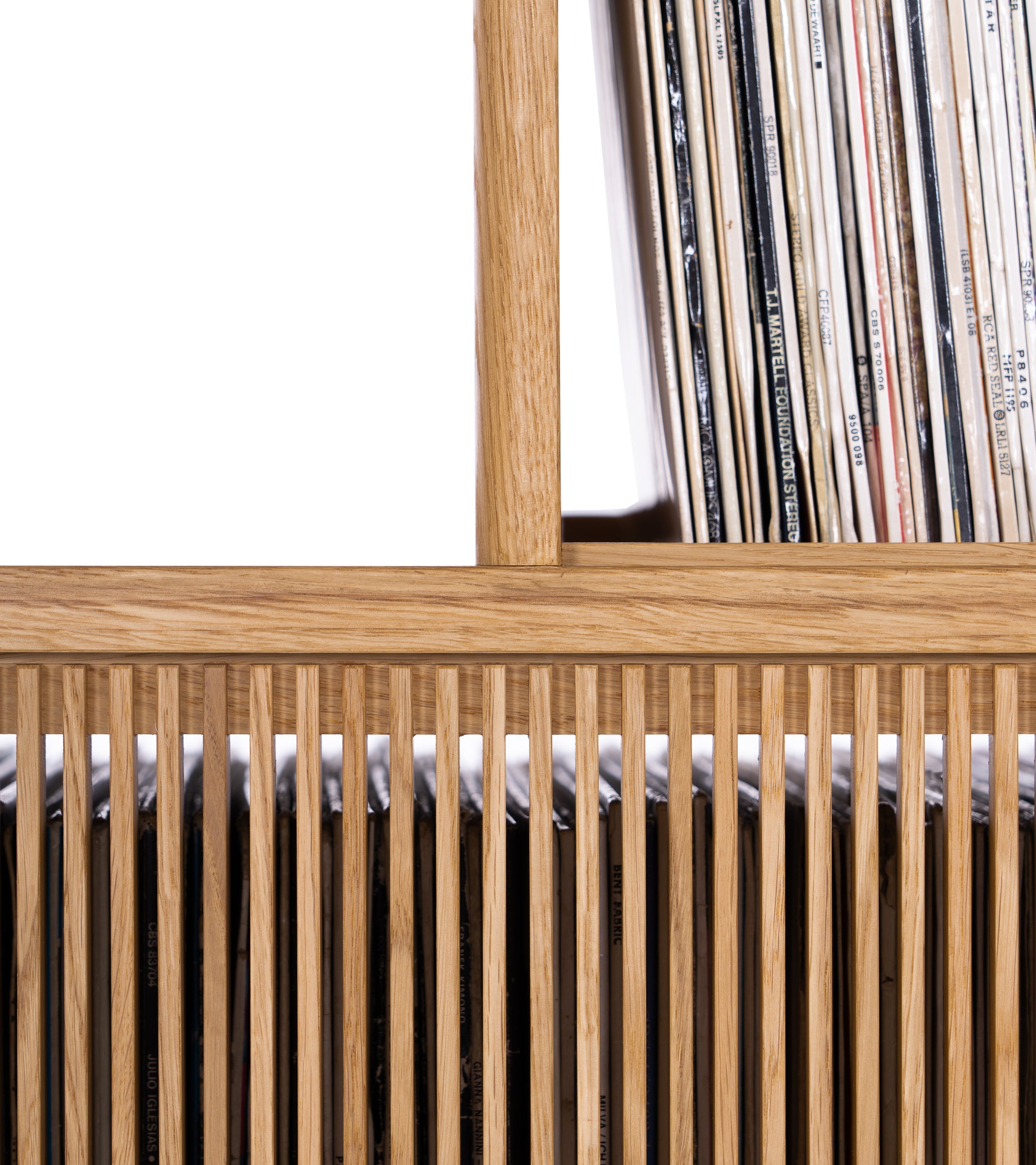 Wooden slatted shelf filled with vinyl records.