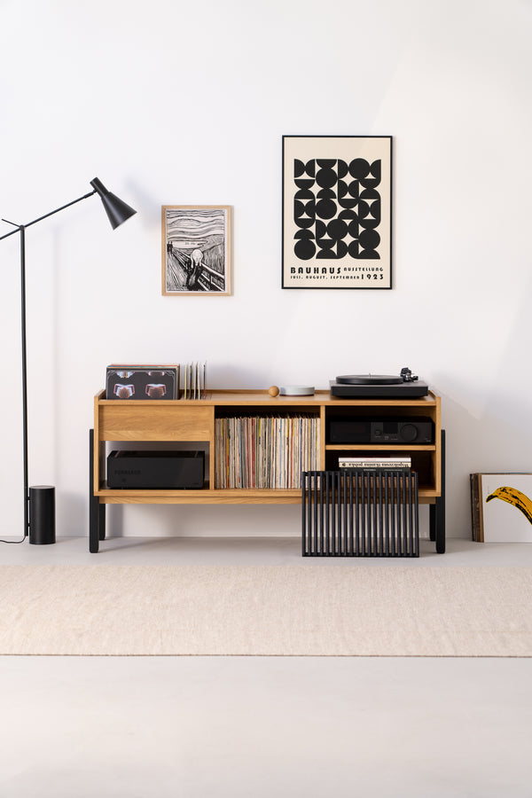 Minimalist room featuring a wooden console, vinyl records and modern wall art - a cozy space for music lovers.