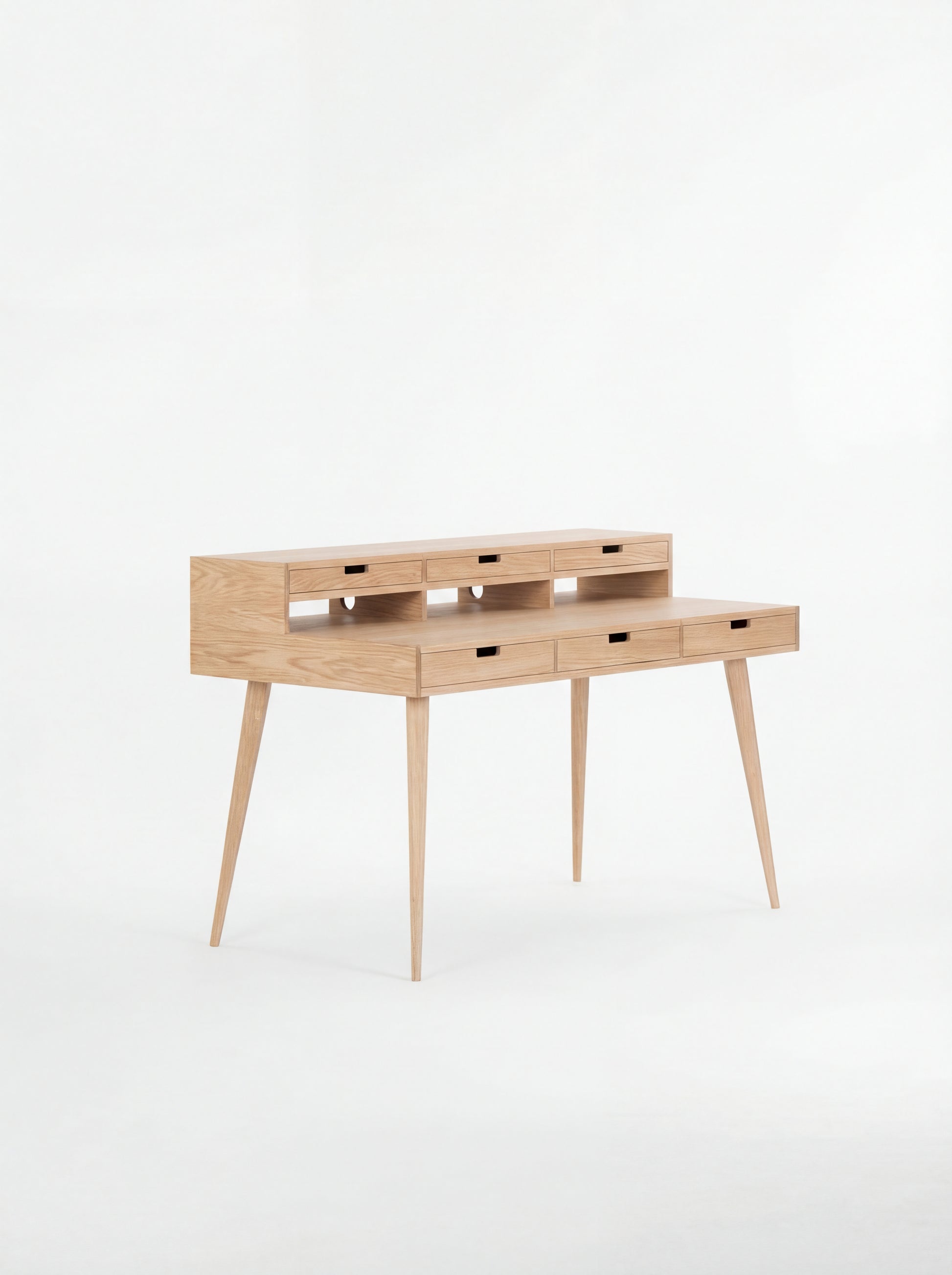 Wooden writing desk with slim legs and multiple drawers, set against a white background.