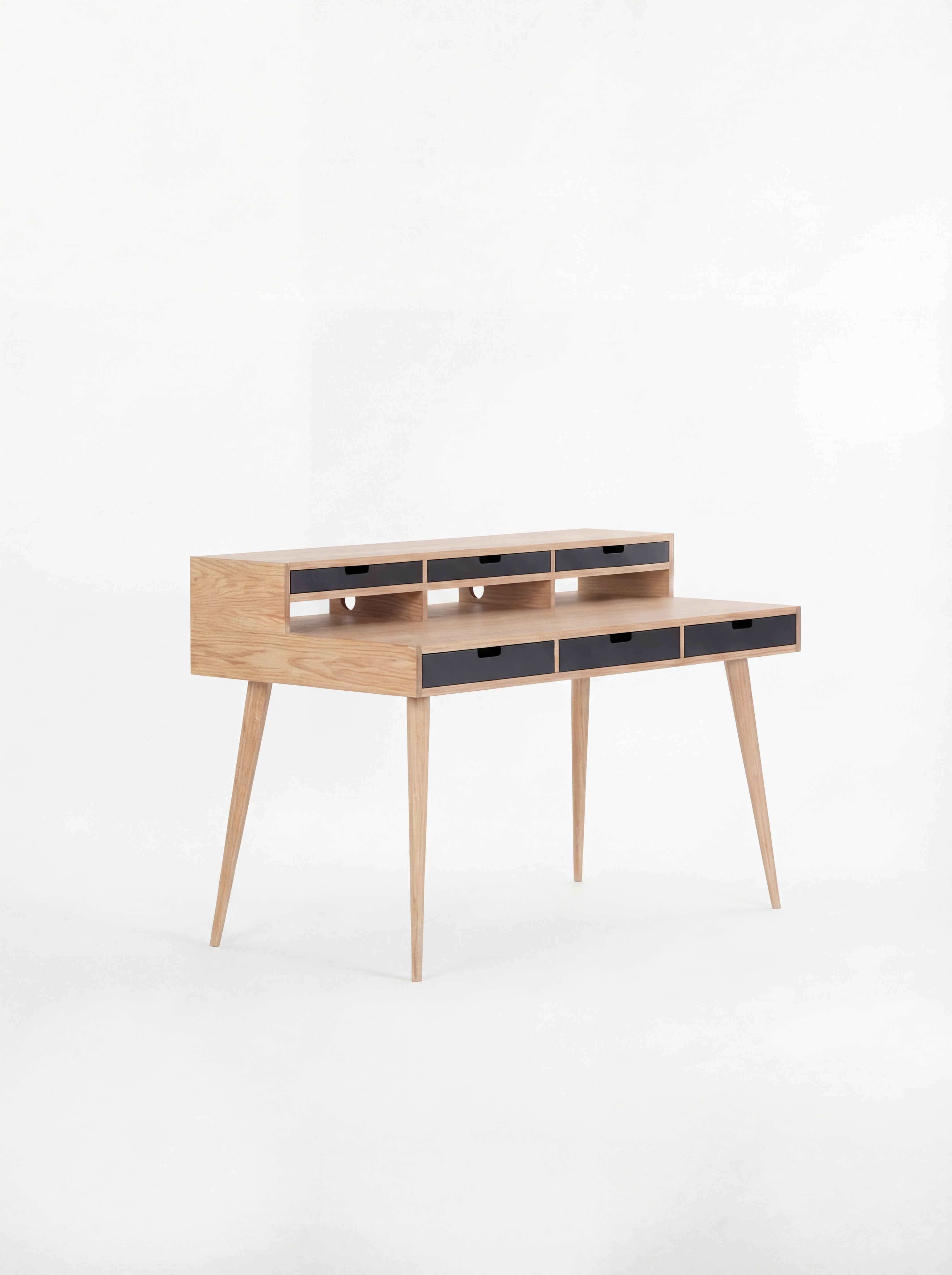 Wooden writing desk with slim legs and multiple drawers, set against a white background.