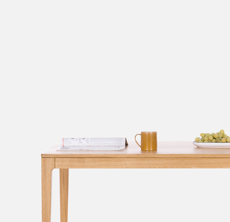 Solid oak wood table on a white background. Solid wood dining tables