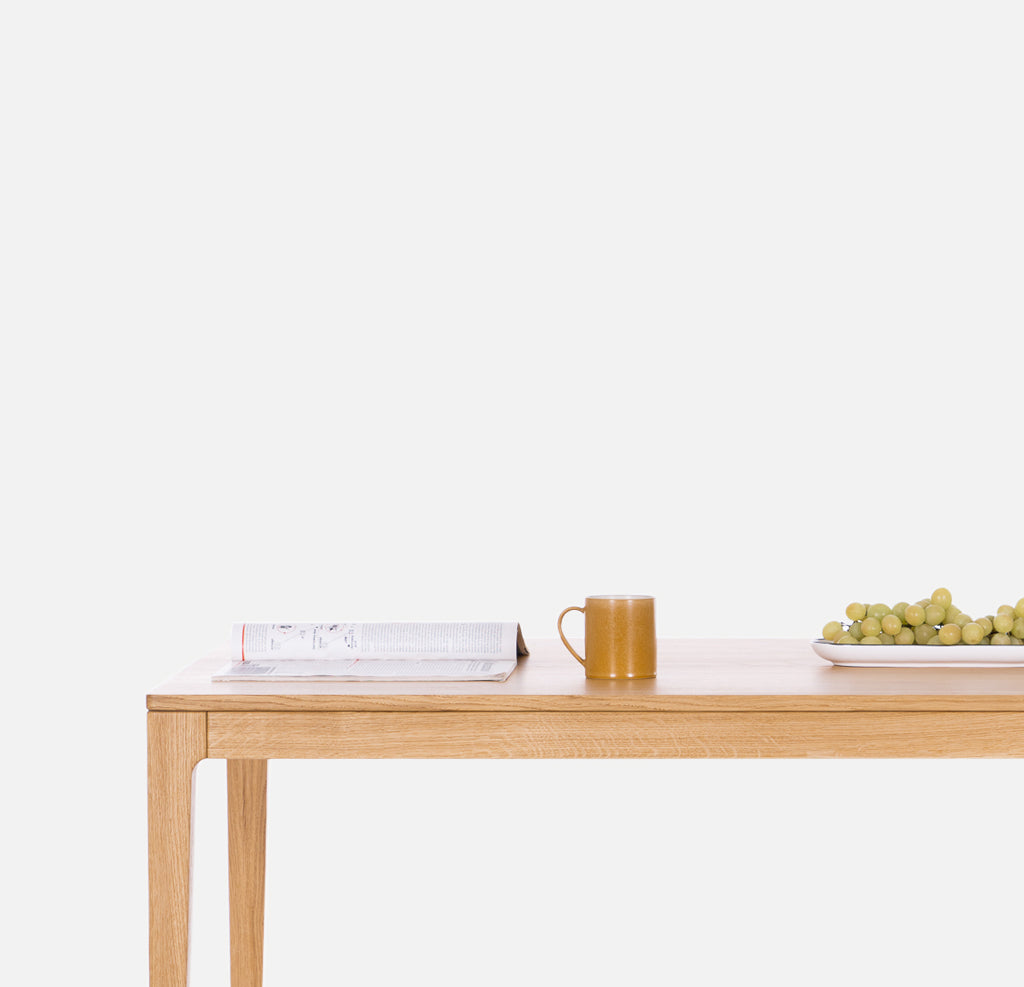 Solid oak wood table on a white background. Solid wood dining tables