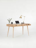HEIM 140 computer desk with drawers in solid oak, seen at an angle with the right drawer open and a laptop on top