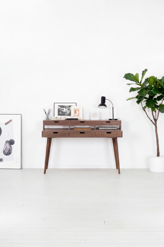 HEIM 140 computer desk with hutch in solid walnut, front view in a bright room with a plant and poster