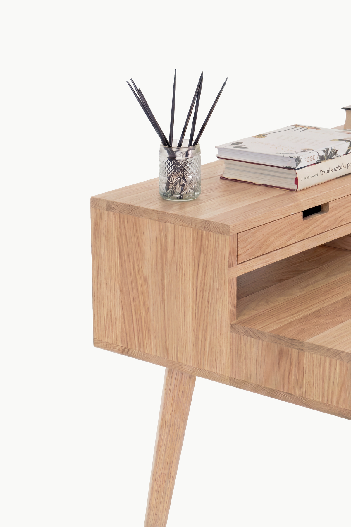Close-up of the HEIM 140 in solid oak, showing the hutch's side panel, cut-out drawer grip and open niche