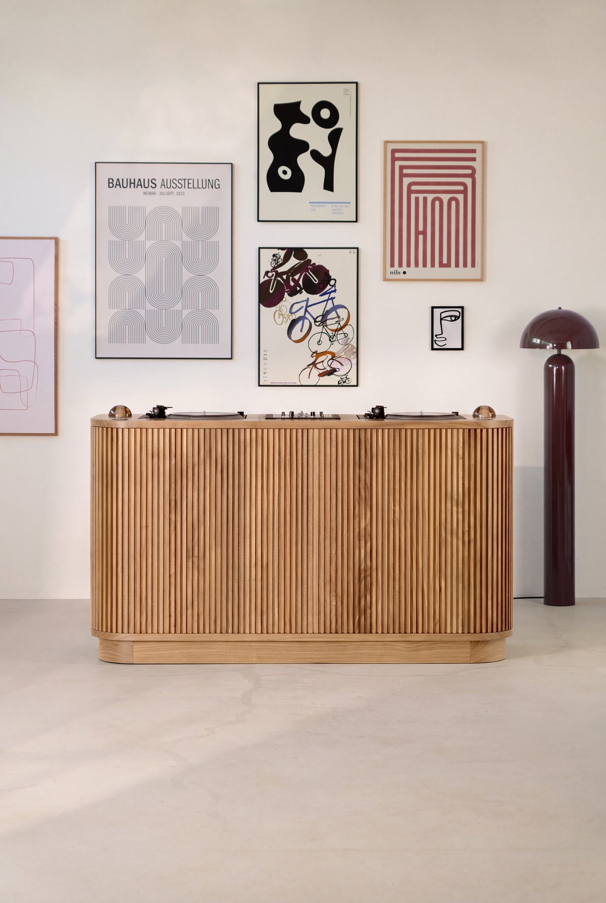 LOOP DJ desk in solid oak, seen from the audience side with a grooved front, turntables and glass dome lights