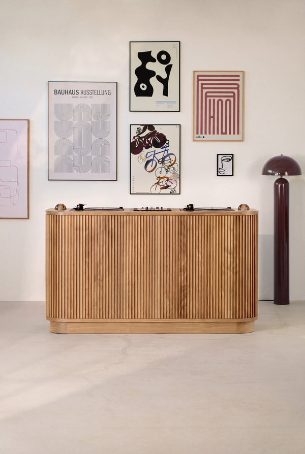 LOOP DJ desk in solid oak, seen from the audience side with a grooved front, turntables and glass dome lights