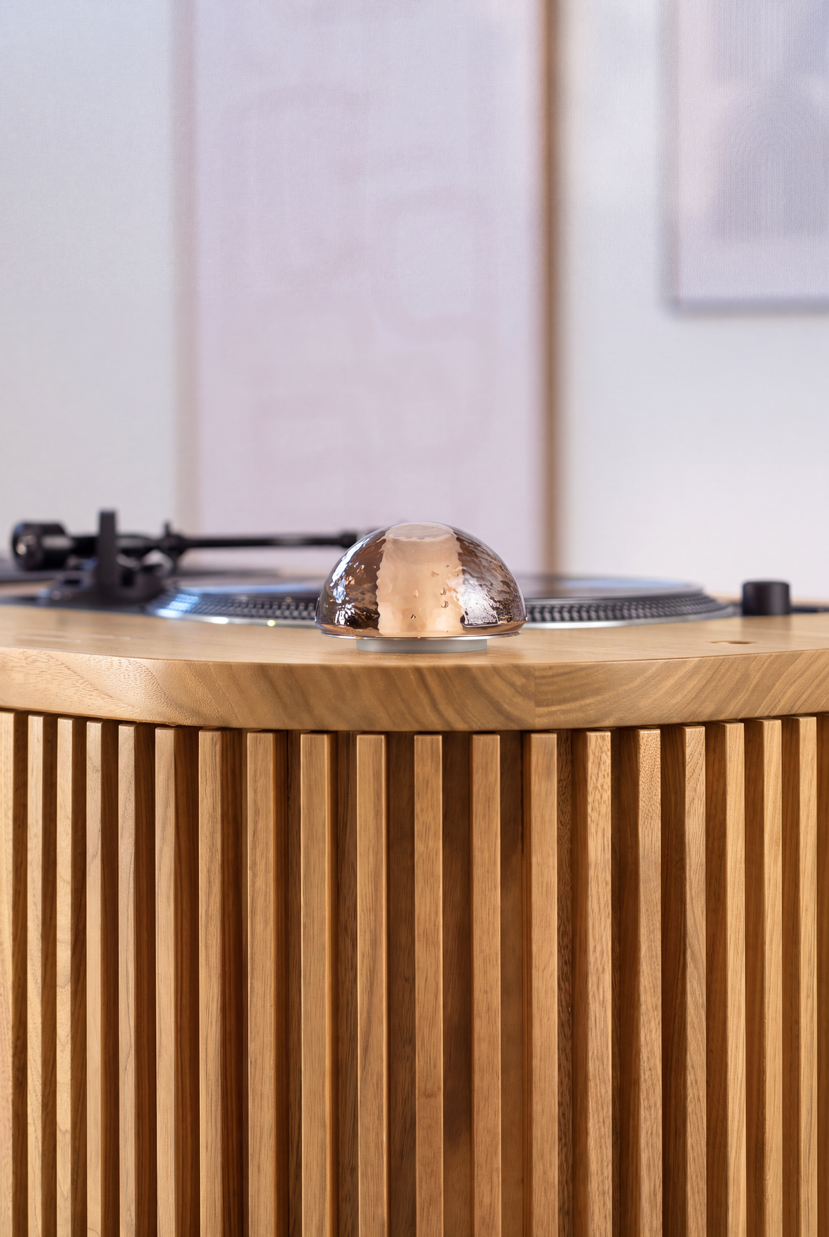 Close-up of a glass dome light on LOOP in solid oak, with a turntable behind and the grooved front below