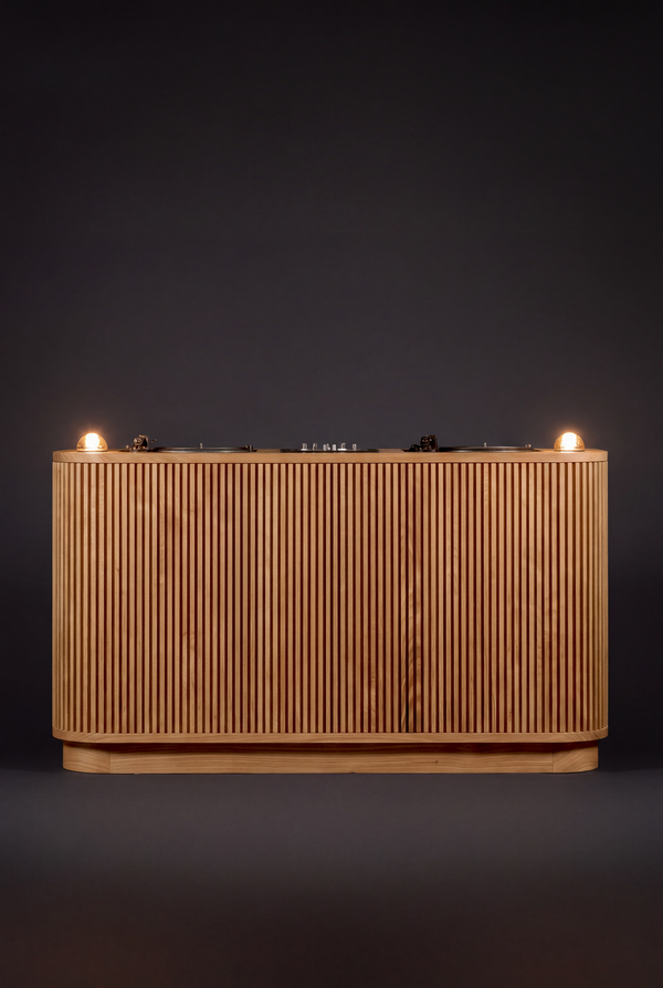 LOOP in solid oak, seen from the audience side against a dark background with both glass dome lights lit