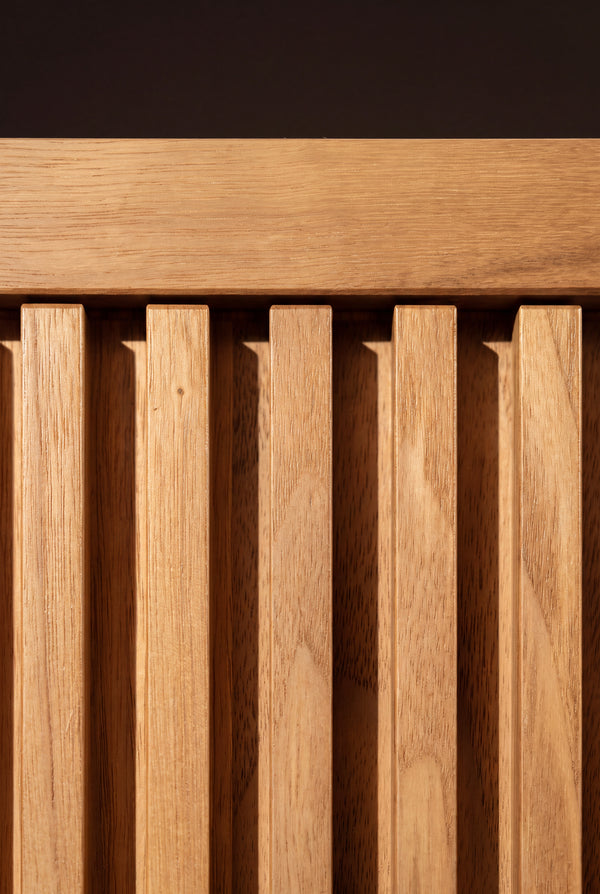 Macro detail of LOOP in solid oak, showing milled vertical grooves below the front rail