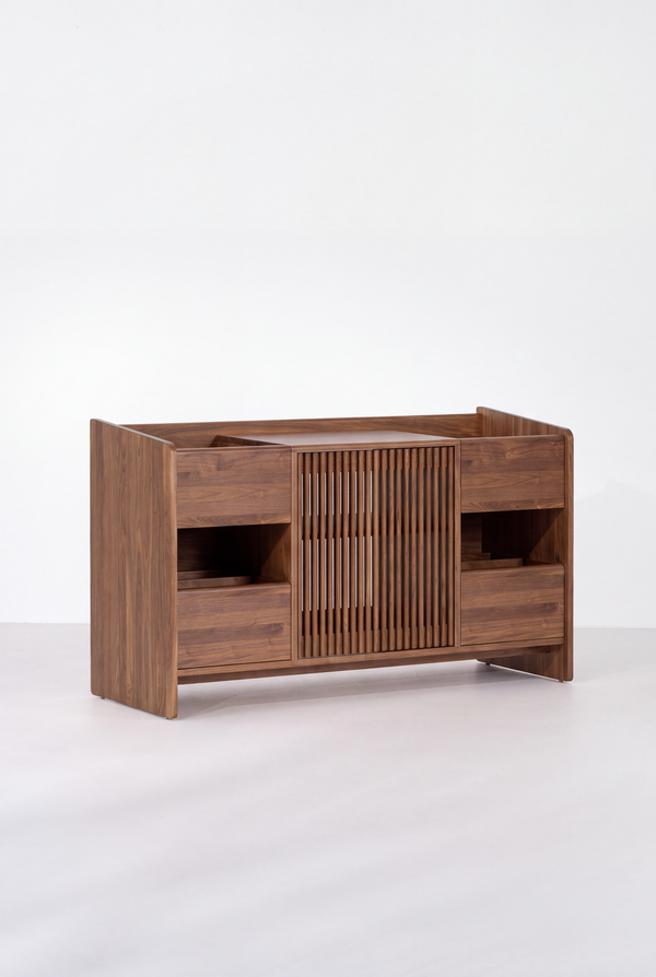 Empty FUSE X in solid walnut on a light background, viewed at an angle with its slatted door closed